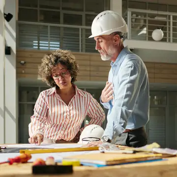 S-Works team and client reviewing project plans built on long-term client relationships