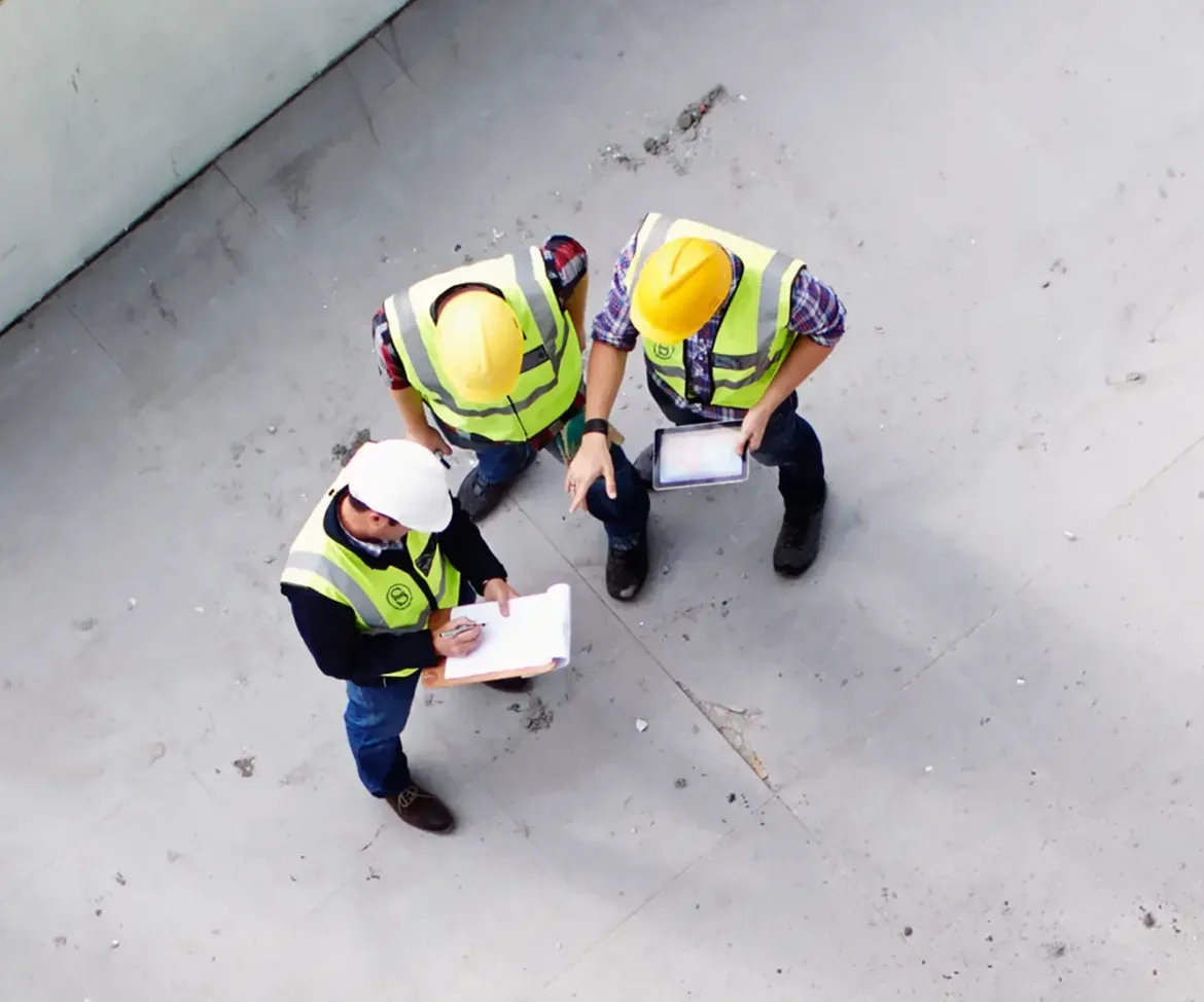 Construction managers reviewing plans on site
